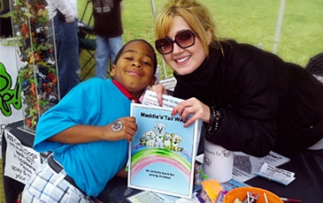 A boy and volunteering with Maddie's Tail Wag